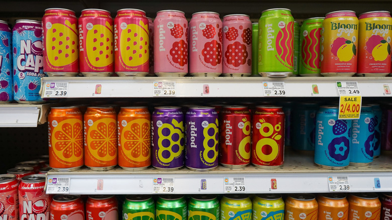 Shelves of different prebiotic soda brands at a grocery store