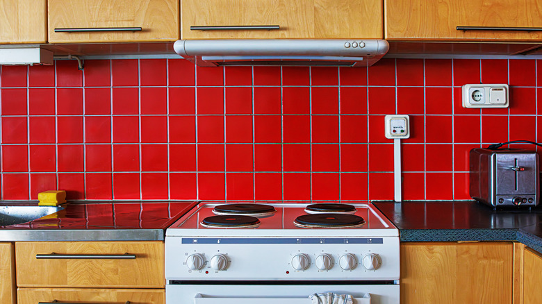 red tile backsplash behind electric oven