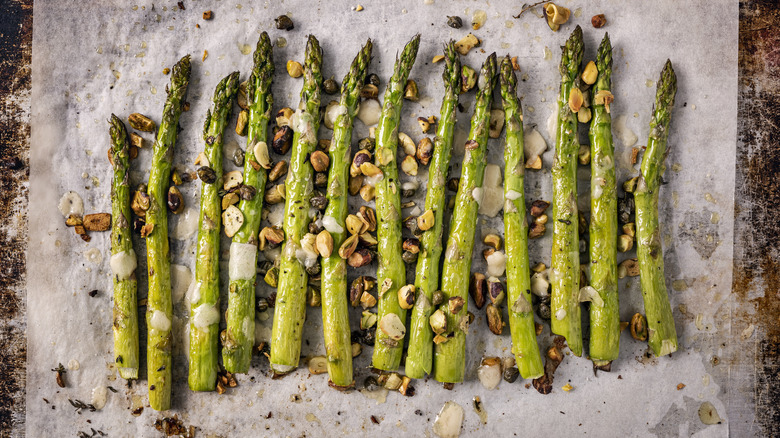 roasted asparagus with seasonings on parchment paper