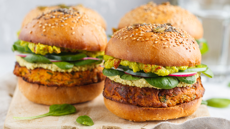 Two veggie burgers loaded with ingredients 