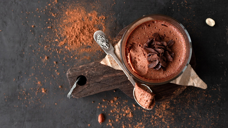 chocolate mousse, spoon, cutting board