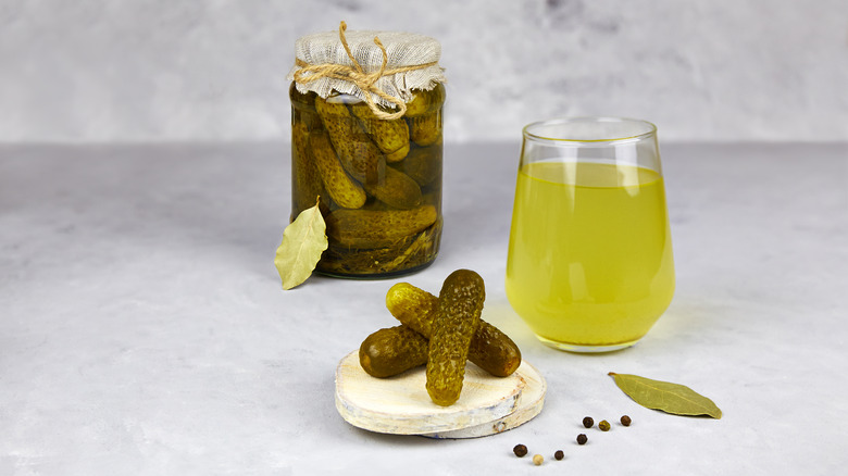 pickle juice in glass with pickles