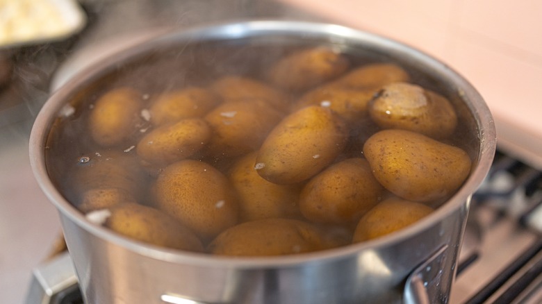 russet potatoes in pot of water