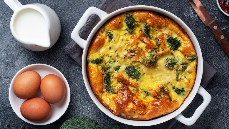 Breakfast casserole next to eggs and milk 