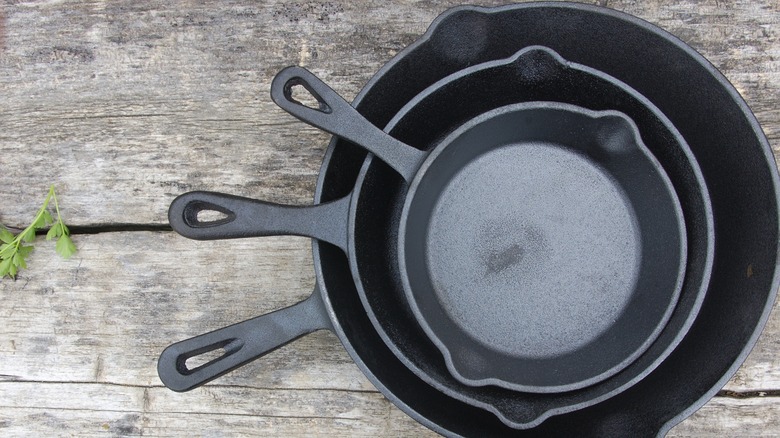 Cast iron pans on wooden table