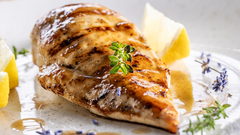 grilled chicken with lemon and lavender on a plate