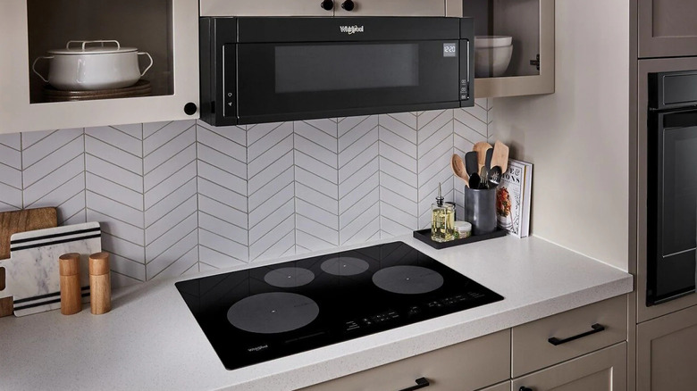 A Whirlpool WCI55US0JB induction range installed in a kitchen