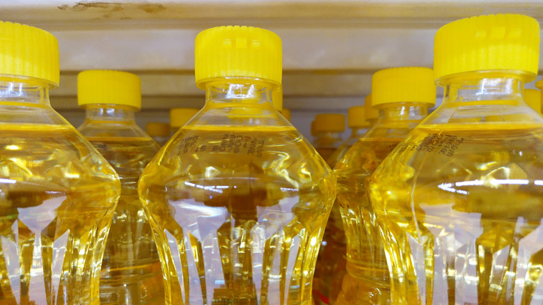 Rows of vegetable oil bottles on a shelf