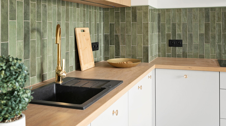 sealed wooden counters with green tile backsplash