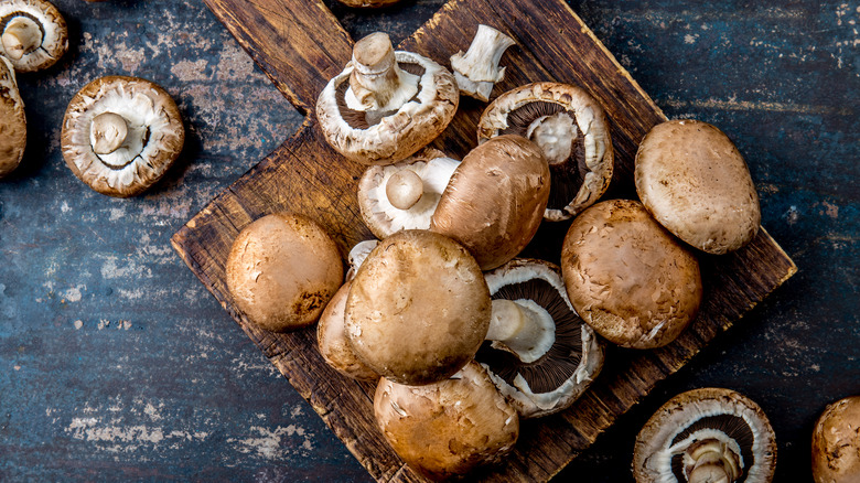 Portobello mushrooms on cutting board 