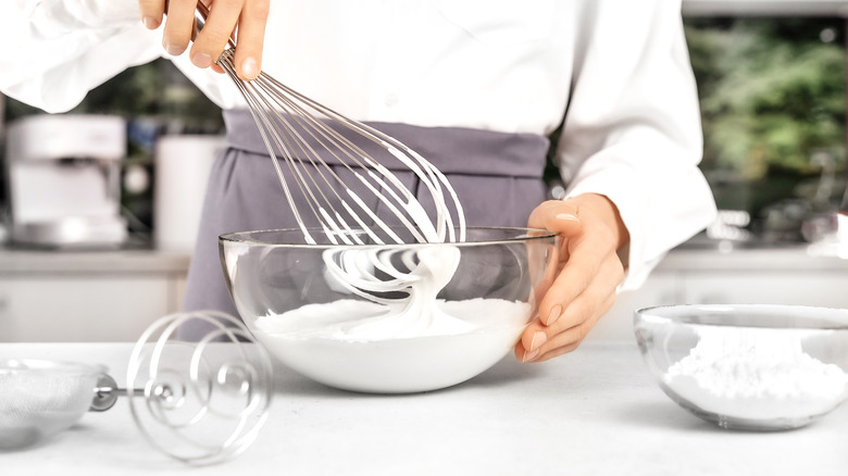 a person making whipped cream