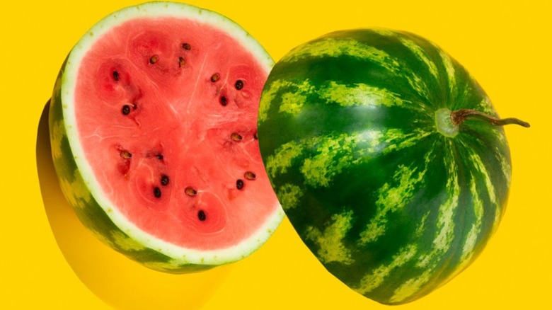 Halved watermelon on a yellow background