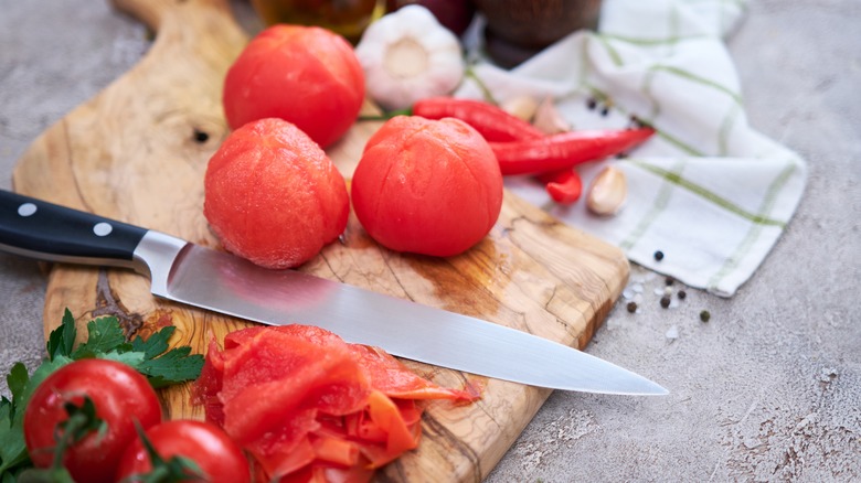 peeled tomatoes on a cutting board