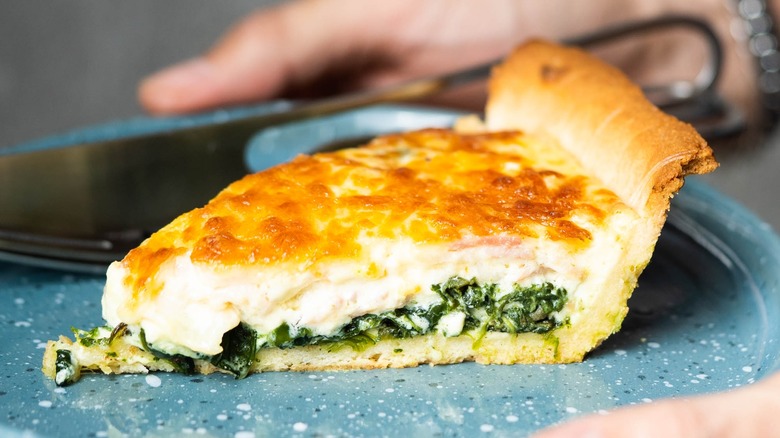 Slice of quiche with spinach