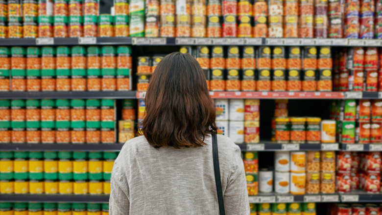 Back of person standing in canned food aisle