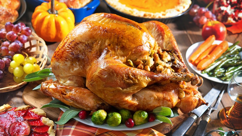 Stuffed turkey on table with side dishes