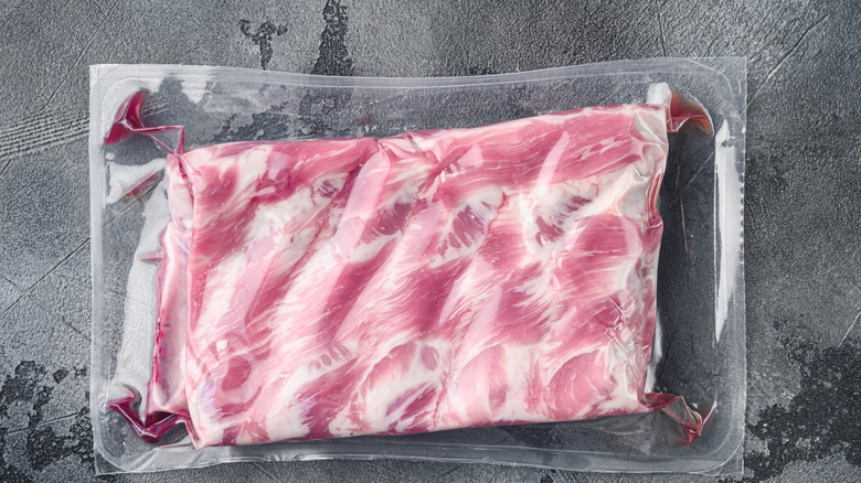 Vacuum-sealed pork ribs in packaging