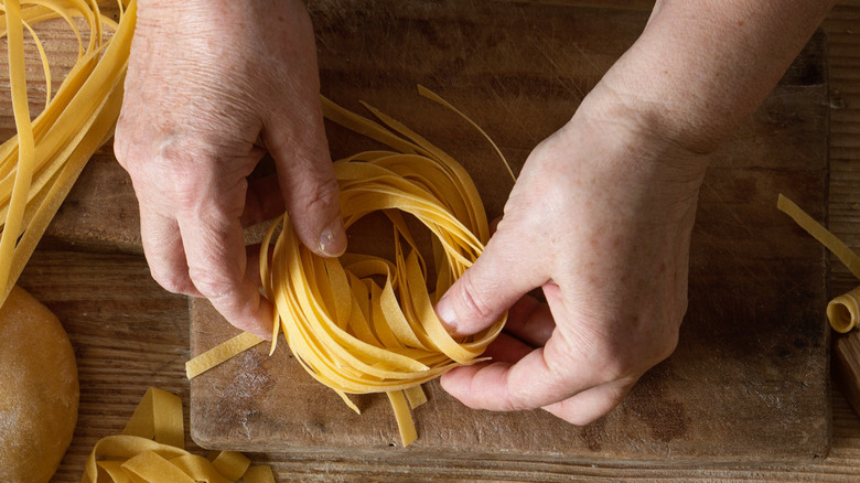 Hands shaping fresh pasta