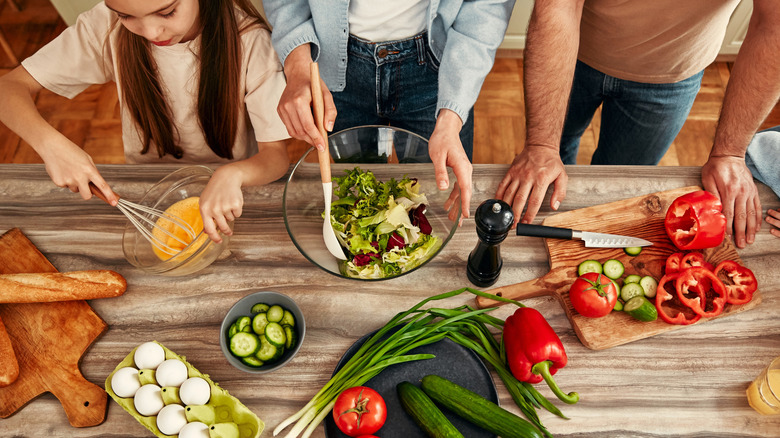 Family cooking together in kitchen