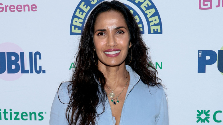Padma Lakshmi smiling in light blue outfit