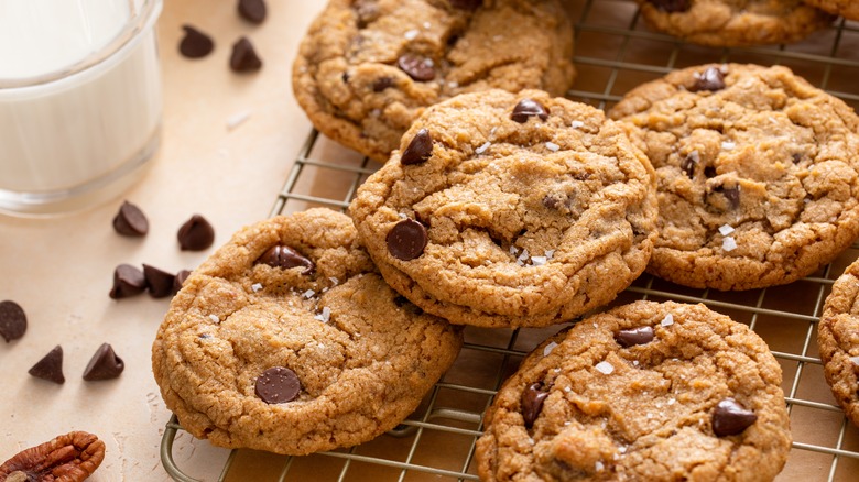 Chocolate chip cookies resting on a wire rack