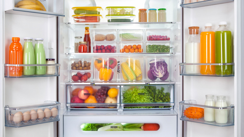 Open, French-door fridge with produce in clear containers