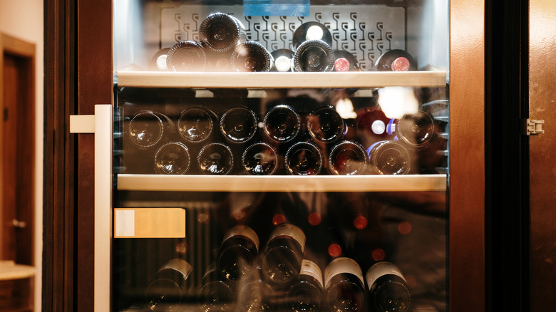 Glass-doored wine cooler with wines stored horizontally inside