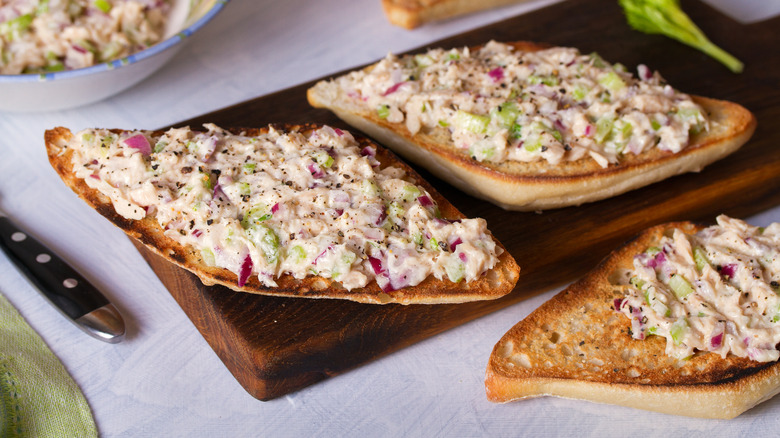 tuna salad spread onto slices of bread