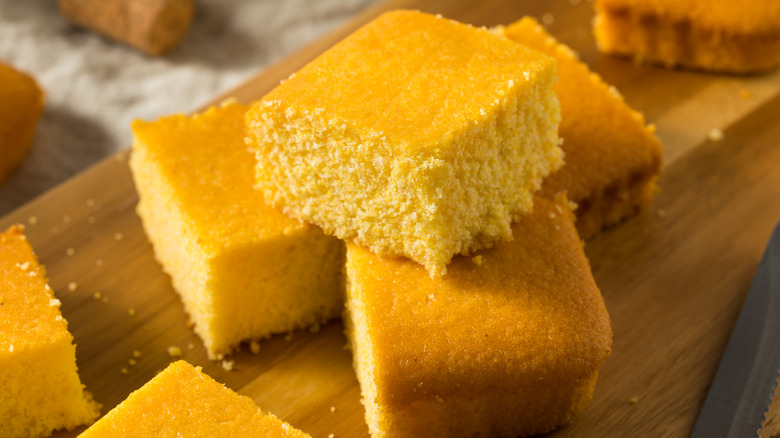 cut squares of cornbread on wooden board