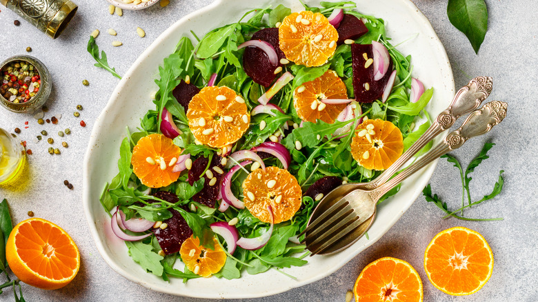 Overhead view of arugula salad with fresh oranges
