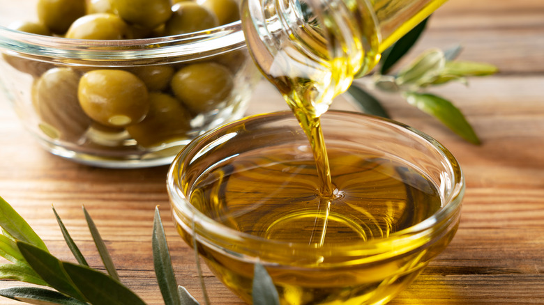 whole olives behind olive oil