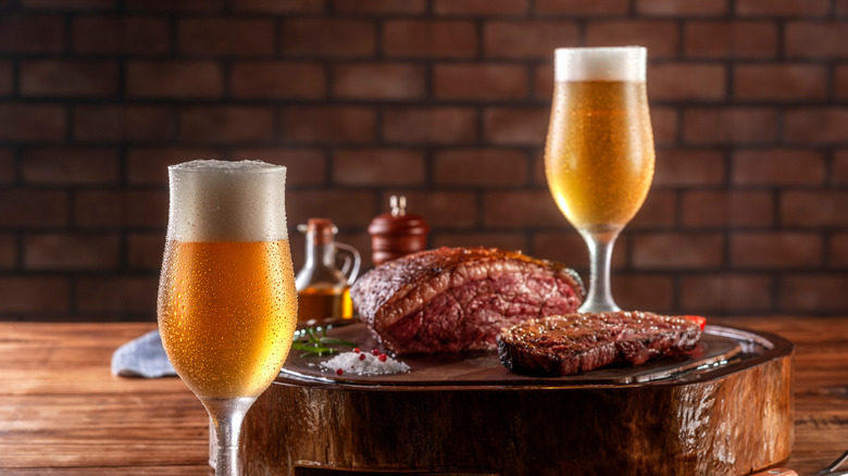 Beer and steak on a table