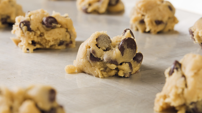 Cookie dough sits on baking sheet