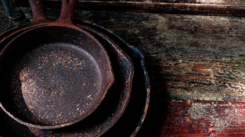 Rustic cast iron pans on wood