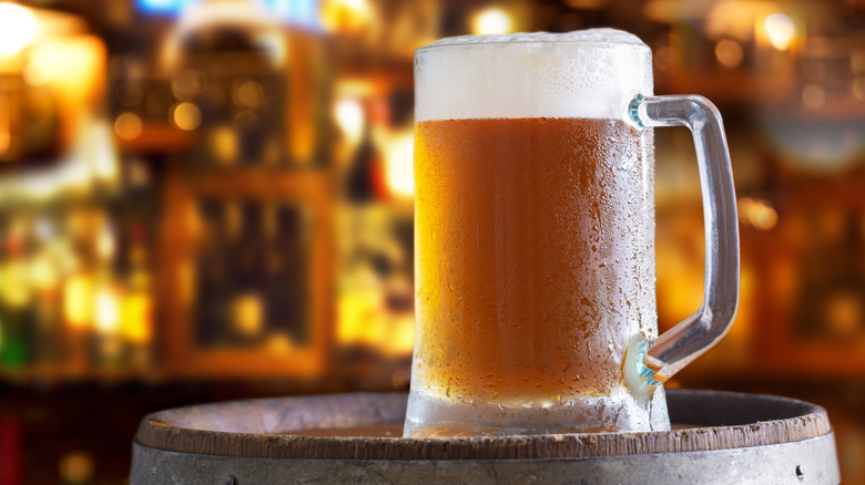 frosty beer mug on beer barrell
