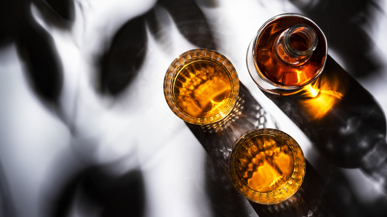 bourbon bottle served in glasses 