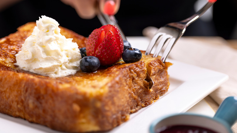 Thick-cut French toast with berries and whipped cream