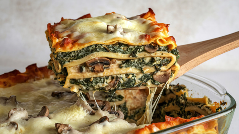 Spoon of vegetable lasagna with spinach