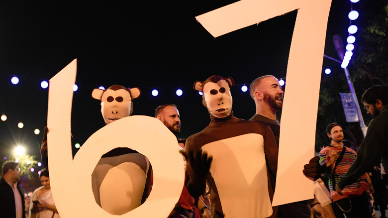 people in costume holding 67