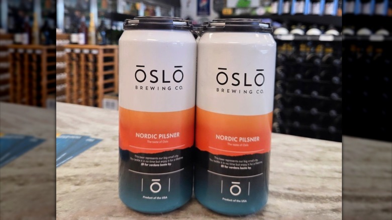 Two Oslo Brewing beer cans in bottle shop