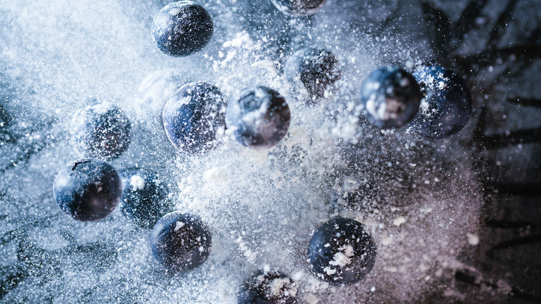 Close up of blueberries being tossed in flour