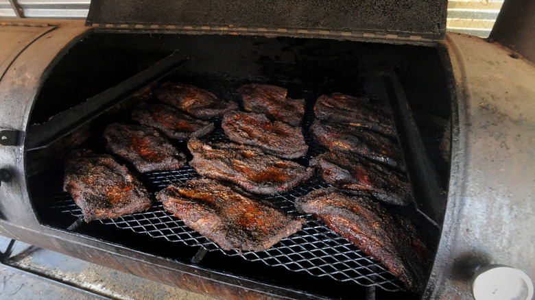 group of briskets in a smoker
