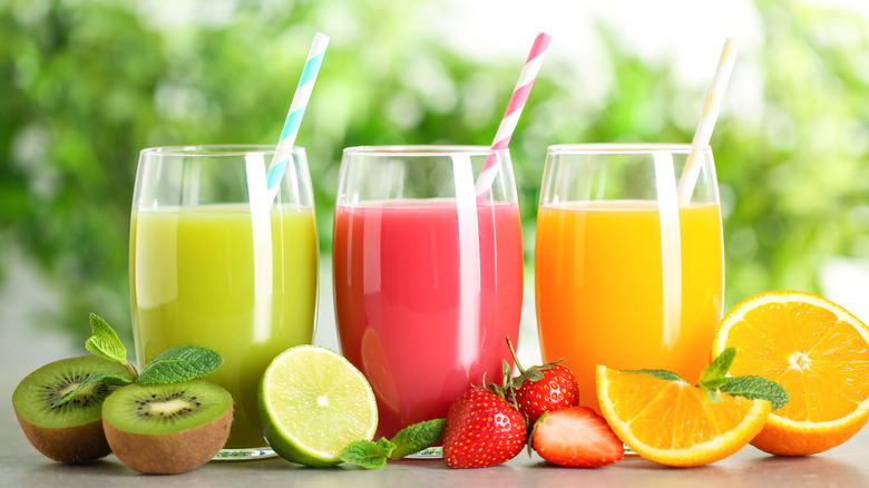 Three fruit drinks with straws
