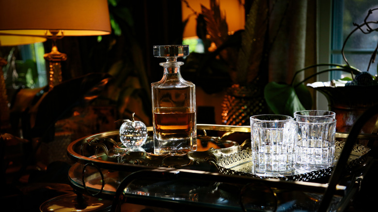 Liquor decanter and rocks glasses sitting in a home bar