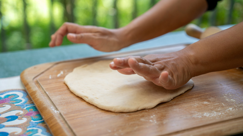 Person making pizza dough at home