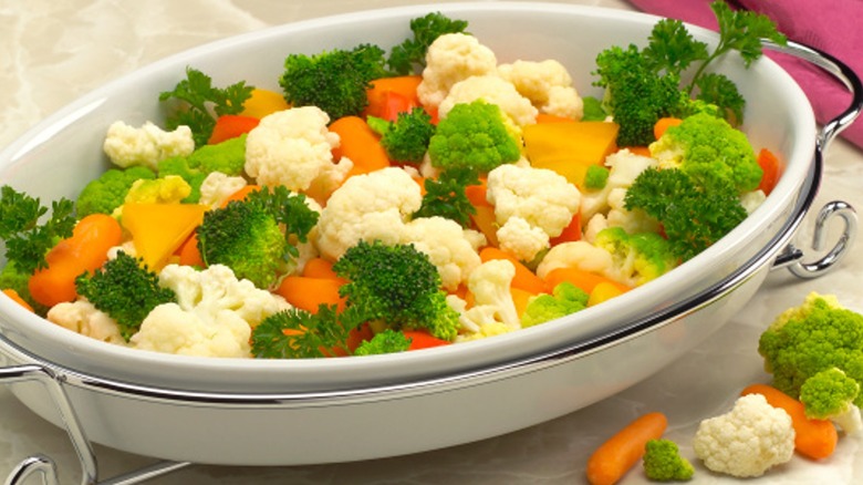 mixed vegetables in a white serving dish