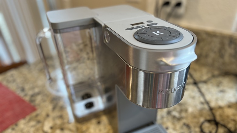 A silver Keurig machine sitting on a countertop