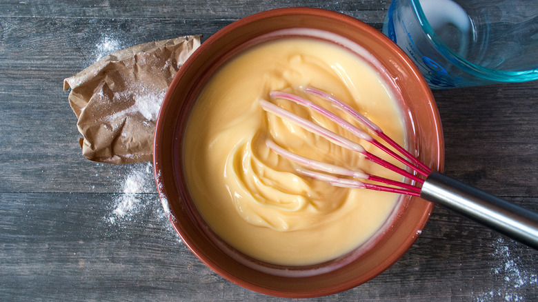 overhead shot of pudding being mixed in bowl with whisk