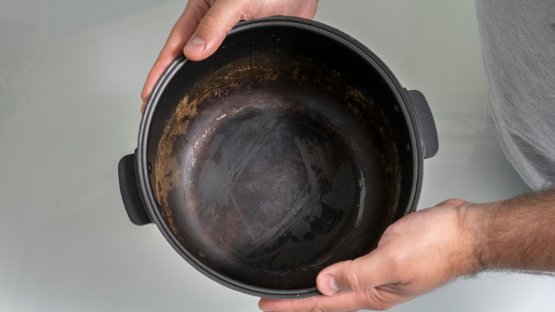 A dirty slow cooker insert