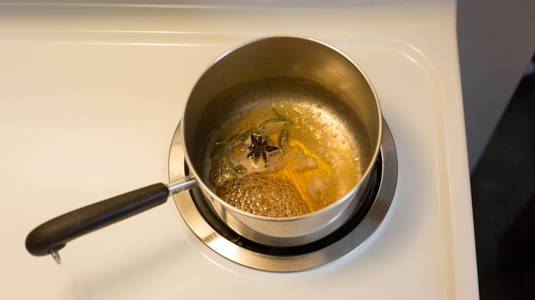 infused honey simmering in pan